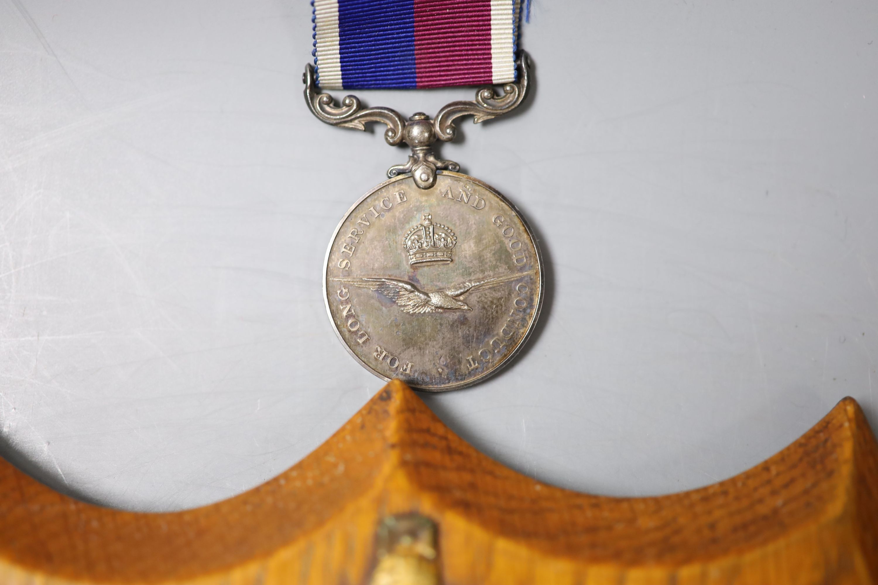 A group of three medals to Flight Sergeant H V Walder RAF 329595 including a George V RAF long service and good conduct medal and an RAF plaque, presented by all ranks of no.18 (B) squadron